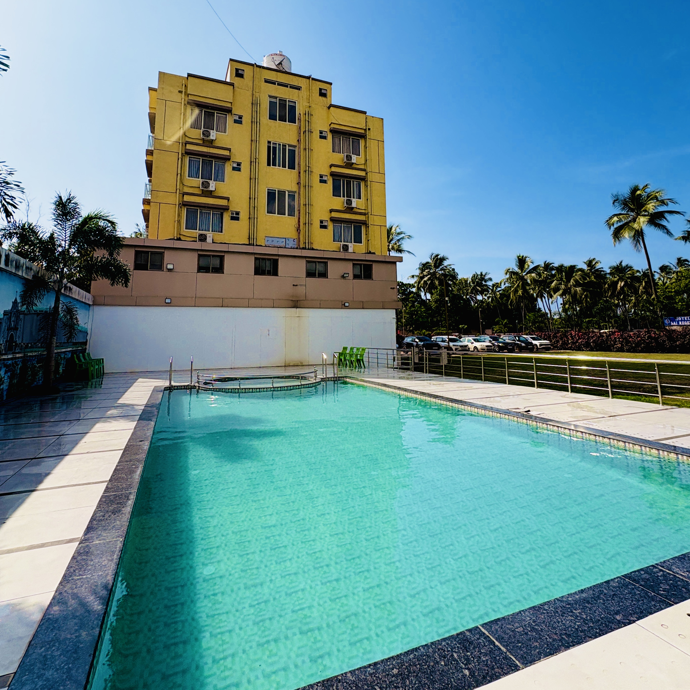 Avron Beach Resort, Daman — poolside with palm gardens